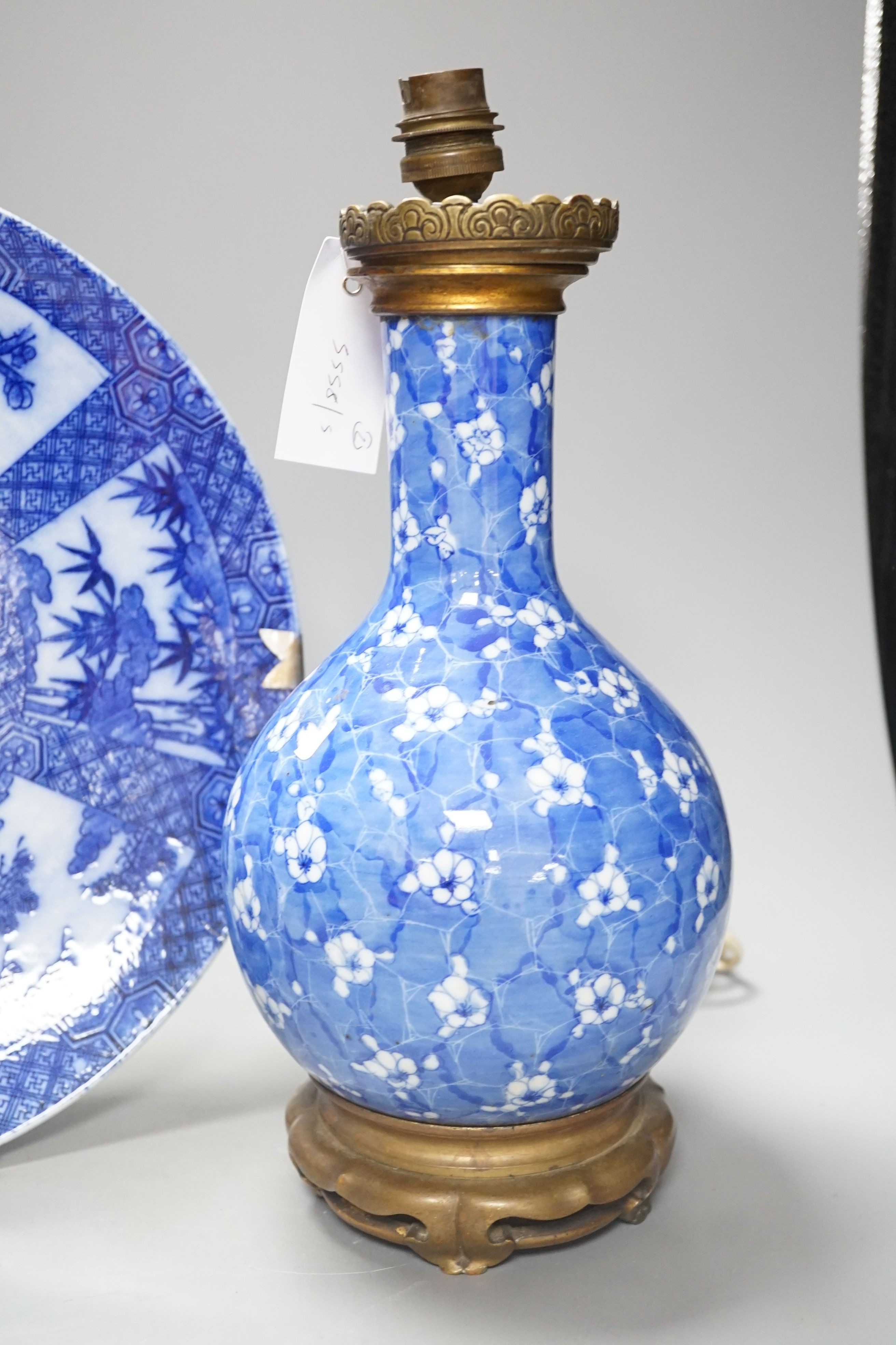 A Japanese prunus blue and white vase now as a lamp, together with a blue and white charger, 34cm diameter